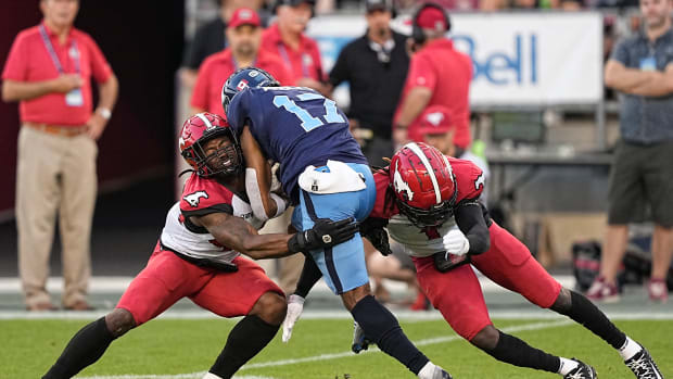 Aug 20, 2022; Toronto, Ontario, CAN; Calgary Stampeders linebacker Silas Stewart (left) and defensive back Elie Bouka (1) tackle Toronto Argonauts wide receiver Markeith Ambles (17) at BMO Field. Mandatory Credit: John E. Sokolowski-USA TODAY Sports  